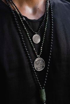 This vintage Tibetan Padma amulet evokes a feeling of an ancient culture, coupled with a modern edge! It is masterfully crafted with a hand-knotted lava stone & silver necklace. The lava stone chain is 57 cm long [app 22.5 in long] Artisan Hand Knotted Necklaces For Meditation, Artisan Hand Knotted Necklace For Meditation, Black Amulet Necklace With Coin Pendant, Meditation Jewelry With Natural Lava Stones, Black Spiritual Necklace With Coin Pendant, Artisan Black Necklace With Oxidized Finish, Lava Stone Jewelry For Meditation With Natural Stones, Hand Knotted Spiritual Jewelry For Festivals, Spiritual Hand-knotted Jewelry For Festivals