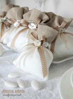 some white eggs are sitting in bags on a table