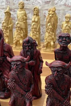 a chess board with some red and gold figurines on it