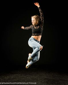 a young woman is jumping in the air