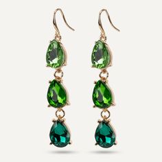 Make a statement with these green emerald crystal earrings. Perfect for adding a little extra colour to a plain outfit. Features cool hues in a modern geometric cut shape. Pair with another piece in our Iris range for ultimate sparkle. Gold-Tone Plated Product Code: DE1173C Collection: Iris Type: Hook Material: Base Alloy & Crystal Dimensions: Pendant Dimensions: Style: Contemporary, Statement, & Geometric Includes: