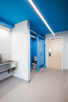 an empty bathroom with blue and white walls