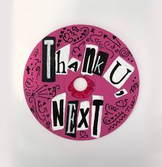 a pink donut with the words thank you next written in black and white on it