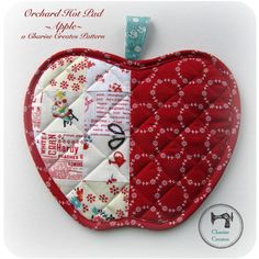 an apple shaped ornament with red and white quilted material on it's side