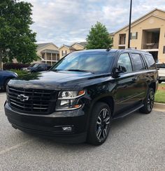 a black suv is parked in the parking lot