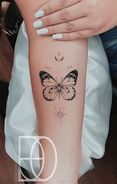 a woman's arm with a butterfly tattoo on the left side of her body