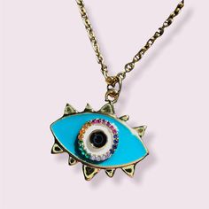 This gorgeous golden eye pendant is has a deep cyan color around an iris of sparkly, rainbow colored cubic zirconia gems. It is simply stunning! The chain is made of golden hypoallergenic stainless steel. Perfect for those who want to celebrate their intuition or flaunt their witchy vibes. Cyan Color, Magic Rainbow, Cyan Colour, Rainbow Eyes, Eye Pendant Necklace, Triangle Earrings Stud, Golden Eyes, Triangle Studs, Geometric Triangle