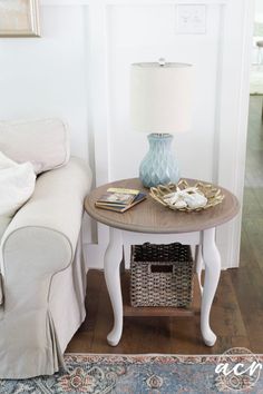 a living room with a couch, table and lamp