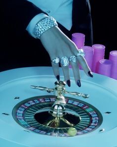 a woman's hand on top of a casino roule