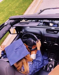 a woman sitting in the driver's seat of a car