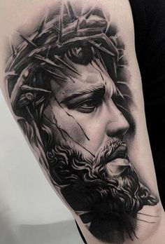 a man with a crown on his head is shown in this black and grey tattoo