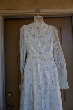 "Gunne sax style or possibly Gunne Sax prairie dress. Zippers at the wrists. Laces at the bust. Good condition - has sewn on back under the laces that could be easily removed - see last photo. Measurements taken across front laid flat 17.5\" across front armpit to armpit 13.5\" across front of waist (ties tighter) 20\" across hips 59\" length" Fitted Long Sleeve Victorian Dress For Spring, Spring Prairie Dress With Lace Trim, Spring Pastoral Prairie Dress With Lace Trim, 1970s Long Sleeve Fitted Prairie Dress, 1970s Style Fitted Prairie Dress With Long Sleeves, Spring Prairie Dress With Lace Trim Maxi Length, Spring Victorian Dress With Lace Trim, Fitted Prairie Dress In Pastoral Style, Fitted Floral Print Maxi Length Prairie Dress