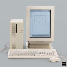 an old computer with a mouse and keyboard next to it on a gray background,