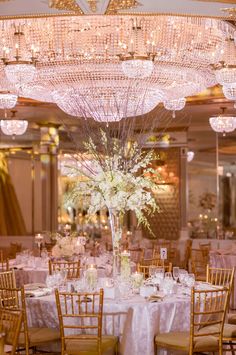 an elegant wedding reception with chandeliers and tables