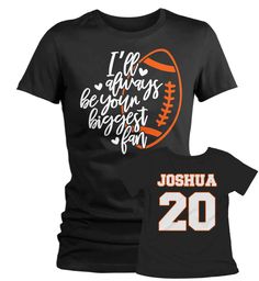 "Women's Personalized Football T Shirt Biggest Fan Shirts Custom Football Mom Shirt Personalized Football Shirt This personalized football shirt is perfect for your son or daughter's, niece, nephew, granddaughter or grandson's next game! The front will read 'I'll always be your biggest fan ' with a football and the back will be personalized with the name and number of your choice in a large athletic font. Made of soft ring spun cotton and includes a cotton muslin drawstring gift bag. Personaliza Black Tops With Name Print For Fan Gear, Football Season Team Name Sports Fan Shirt, Football Season Fan Merchandise Shirt, Football Season Fan Gear Shirt, Football Season Fan Merchandise Shirt With Crew Neck, Pre-shrunk Football Season Sports Fan Shirt, Pre-shrunk Sports Fan Shirt For Football Season, Sports Fan Tops With Name Print For Fan Merchandise, Crew Neck Football Season Fan Shirt