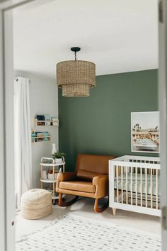 a baby's room with green walls and white rugs