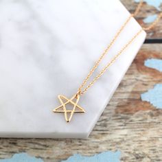 "Beautiful and lovely rose gold pentagram little star charm necklace. Made of rose gold plated tiny pentagram star charm with skinny rose gold chain. Soft and warm looking dainty necklace is good for yourself or gift ! Your necklace will ship in a rudiana gift box. * Rose Gold Plated over Brass * Necklace Length 15\"-20\" * Star Charm 1/2\" * Creation Time : 1 - 3 days * US shipping transit time : 3-5days * International shipping normally takes 7-14days ♥ See more Rudiana Accessories Rudiana.ets Dainty Star Of David Charm Necklace For Gift, Star Charm Necklace, Rose Gold Chain, Brass Necklace, Jewelry Stand, Necklace Dainty, Star Charms, Dainty Necklace, Star Necklace