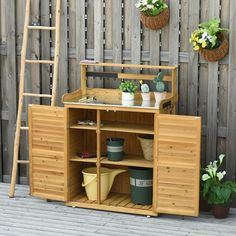 a potted plant sitting on top of a wooden shelf next to a garden ladder