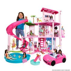 a girl plays with her doll house and pool