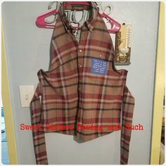 a plaid shirt hanging up on a door hanger with a tag that says sweet children's clothing and such