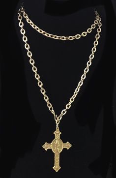 Our Matte Gold Cross of Saint Benedict (aka San Benito) is a sacramental holy medal that has been believed to repel evil for centuries. It hangs on a 34" etched cable chain with a shepherds hook that allows it to be worn an unlimited number of ways because the hook can be fastened on any of the cable links. You can wear it doubled and short of mid length as a lariat or as a long layering piece with your other Whispering Goddess necklaces. The cross itself is timeless and according to the Benedic Engraved Spiritual Medallion Jewelry, Gold Crucifix Jewelry Collectible, Collectible Gold Crucifix Jewelry, Spiritual Hallmarked Crucifix Necklace, Collectible Spiritual Gold Locket Necklace, Spiritual Gold Locket Necklace Collectible, Antique Crucifix Collectible Jewelry, Antique Collectible Crucifix Jewelry, Antique Jewelry With Miraculous Medal For Collectors