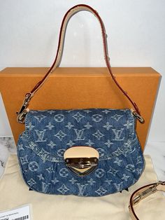 This Louis Vuitton Sunset Bag in Monogram Denim Remix M46829 is a limited edition piece perfect for travel or casual occasions. The bag features a push lock closure, gold hardware, and a detachable strap for versatility. The exterior is made of denim with the iconic monogram pattern and is accented with tan leather handles. The interior is lined in blue denim and includes an original box. This small crossbody bag measures 10.6 inches in width, 7.1 inches in height, and 1.2 inches in depth. The Louis Vuitton High model is designed for women and showcases the brand's signature style as a designer item. This bag is not vintage or customized. Complete set with tags, dust cover, original box with ribbon Hardware may have fine scratches. Smoke free home. No returns Flap Bag In Monogram Canvas With Branded Hardware, Flap Bags In Monogram Canvas With Branded Hardware, Monogram Canvas Bag With Branded Hardware And Flap Shape, Designer Monogram Canvas Flap Satchel, Designer Monogram Canvas Satchel With Flap, Travel Bag With Monogram Canvas And Metal Hardware, Travel Bag With Metal Hardware And Monogram Canvas, Travel Bags With Metal Hardware And Monogram Canvas, Monogram Canvas Shoulder Bag With Turn-lock For Everyday Use