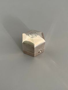 a small silver box sitting on top of a table