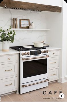 a white stove top oven sitting inside of a kitchen next to a wooden countertop