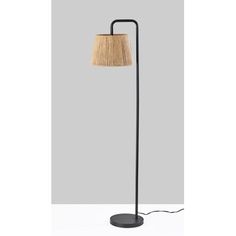 a floor lamp with a light shade on it's side and a black base