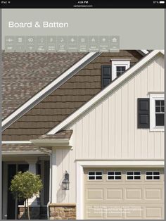 a white house with brown shingles and black shutters on the front door is shown