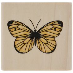 a wooden stamp with a yellow butterfly on it's back and black outlines