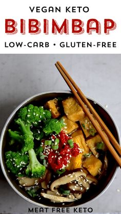 a bowl filled with broccoli, tofu and other vegetables next to chopsticks