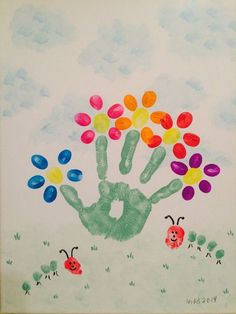 a child's hand with flowers and ladybugs painted on it in the sky