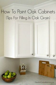 white cabinets in a kitchen with green apples on the counter