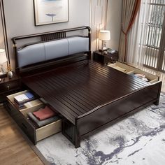 a large bed with drawers underneath it in a room next to a painting on the wall