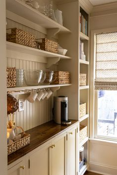 the shelves in this kitchen are filled with dishes