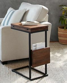 a living room with a couch, chair and table on carpeted floor next to potted plant