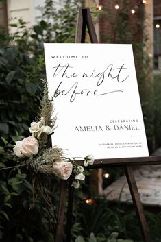 a welcome sign with flowers and greenery on it