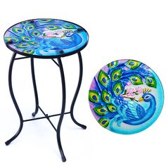 a table with a peacock design on it next to a plate that has been painted