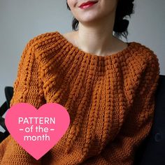 a woman wearing an orange knitted sweater with the words pattern of the month written below it