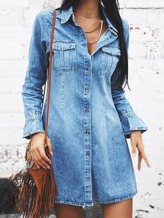 a woman wearing a denim dress and hat