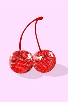 two shiny red cherries on a pink background