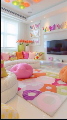 a living room filled with lots of furniture and colorful pillows on top of the floor