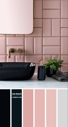 a bathroom with pink tiles and black fixtures