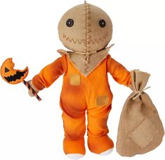 a stuffed animal with a trick bag in it's hand and a jack - o - lantern