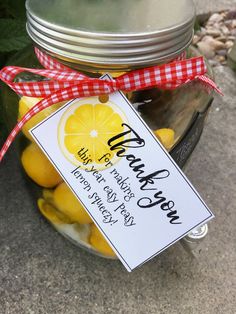 a jar full of lemons with a thank you sign on the front and side