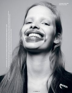 black and white photograph of a woman with her mouth open, smiling at the camera