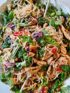 a white plate topped with noodles and veggies