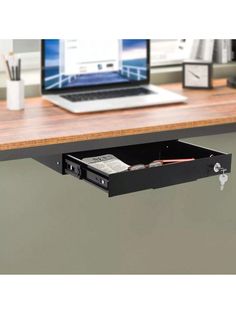 an open drawer underneath a laptop computer on a desk