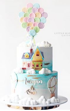 there is a cake with balloons on the top and a house in the middle that says happy birthday